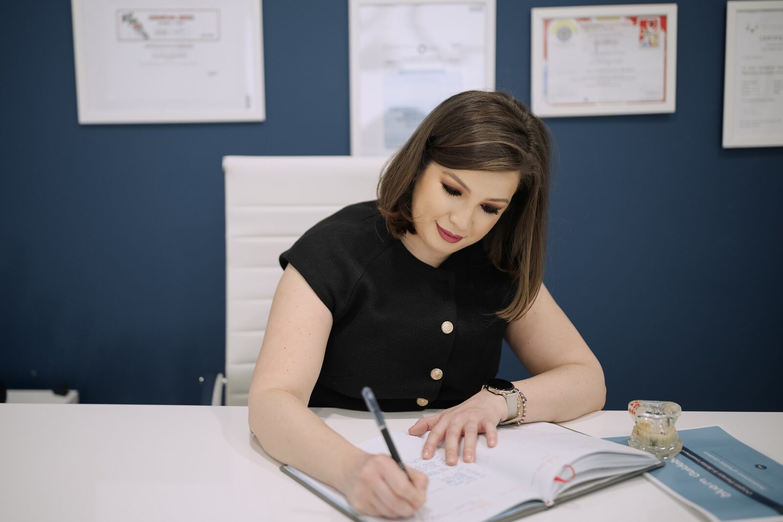 Dr. Bianca writing in a notebook